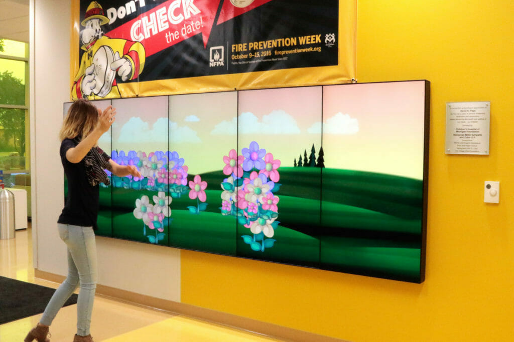 A patient uses the ActivePlay interactive wall.