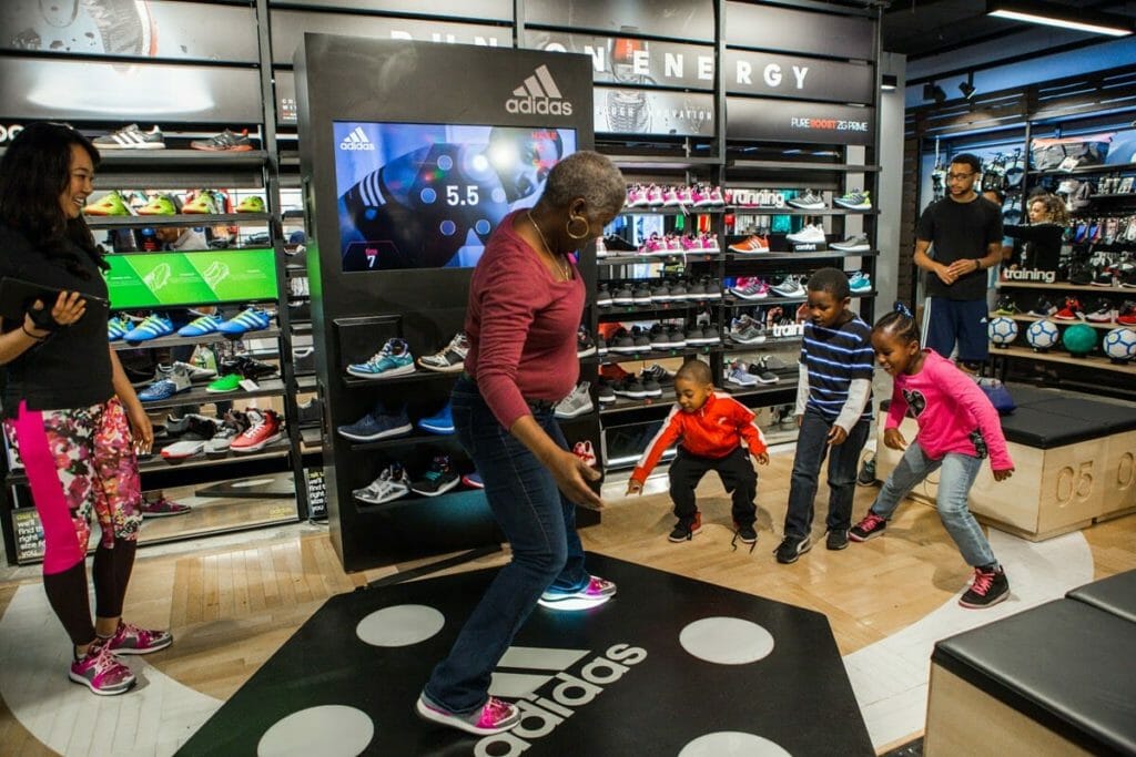 A family interacts with the Adidas Power Pad