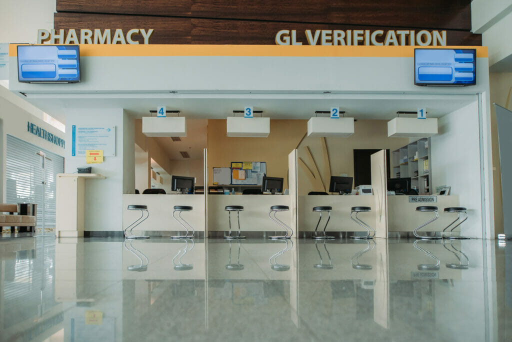 Digital signs showing important information at the pharmacy and registration counter in a hospital.